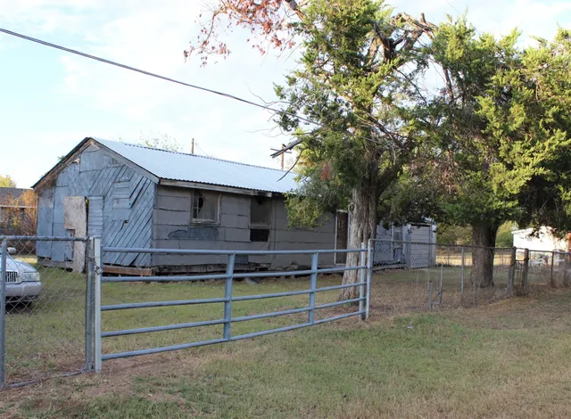 a view of a house with a fence