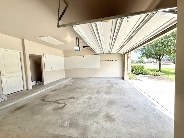 a view of a room with a large window and tree