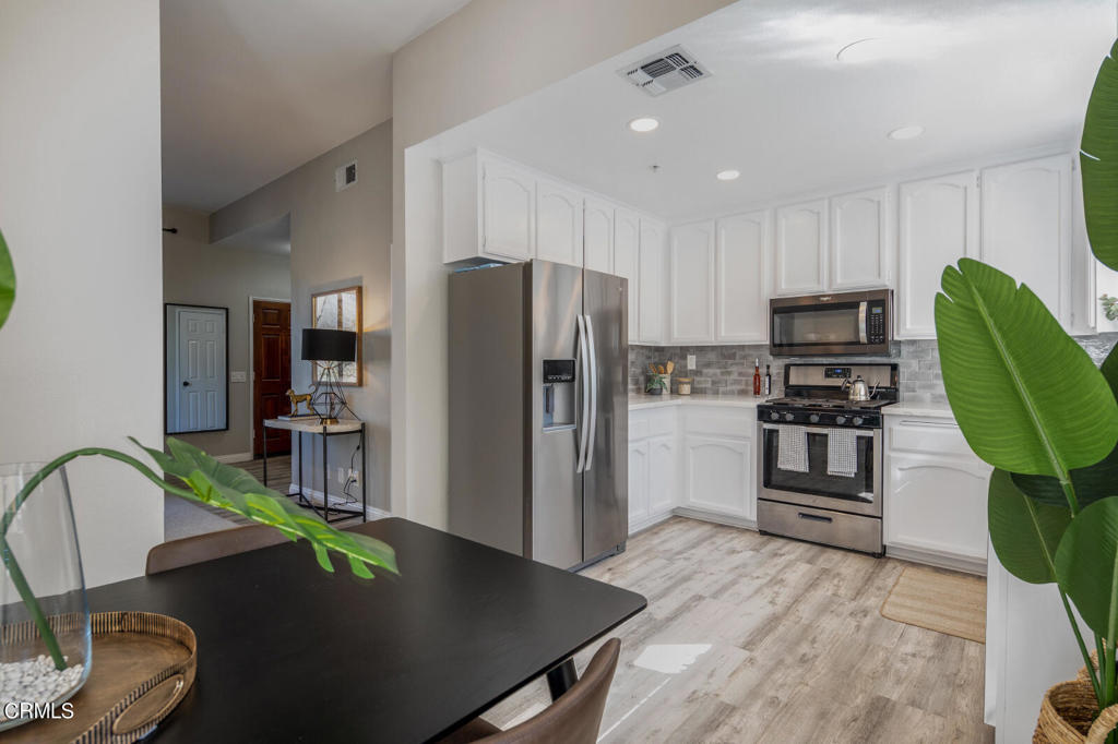 1035 Arroyo Verde Road, Unit B South Pasadena, CA 91030 - Photo 7 of 12 a kitchen with stainless steel appliances granite countertop a refrigerator a stove and a sink with wooden floor