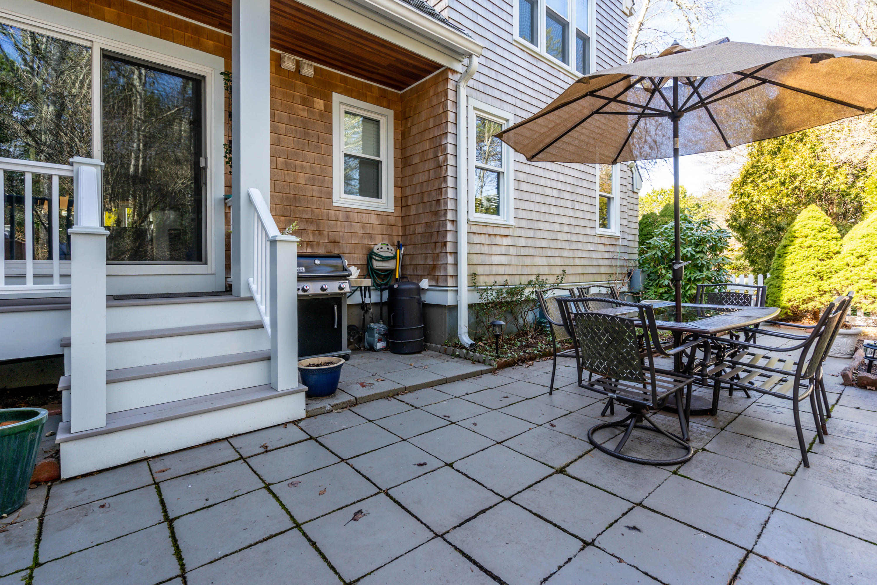 10 Bob White Crescent Mashpee, MA 02649 - Photo 22 of 28 a view of a patio with table and chairs under an umbrella