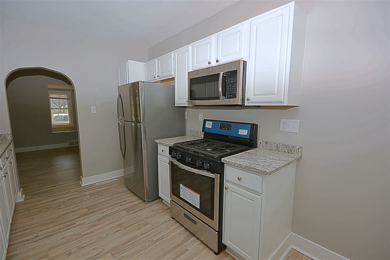 523 10th Avenue Rochelle, IL 61068 - Photo 11 of 22 a kitchen with stainless steel appliances granite countertop a stove a microwave and a refrigerator