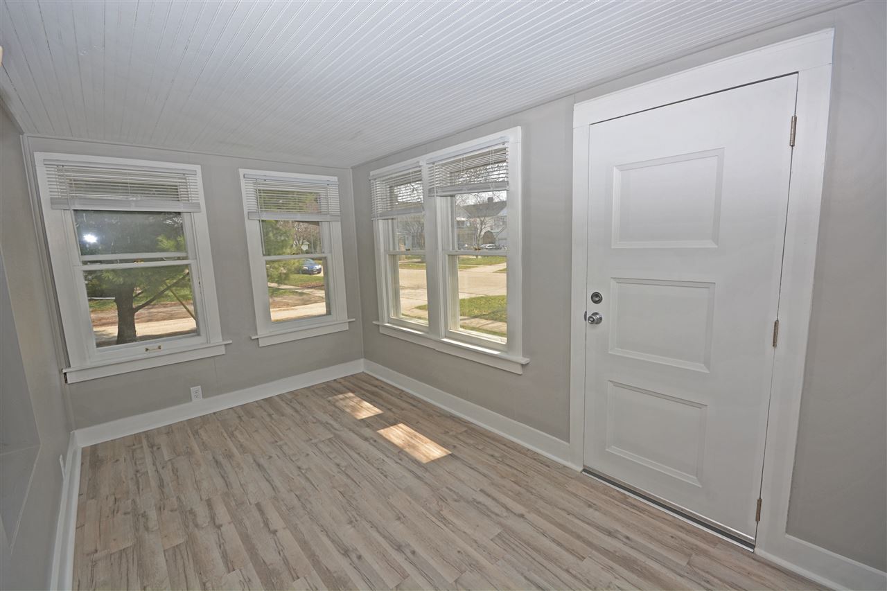 523 10th Avenue Rochelle, IL 61068 - Photo 3 of 22 an empty room with wooden floor and windows