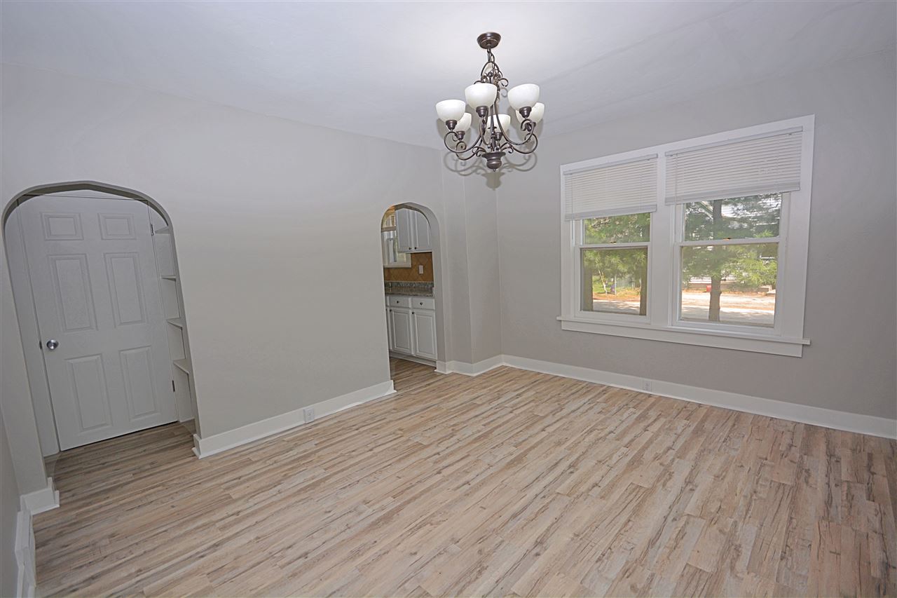 523 10th Avenue Rochelle, IL 61068 - Photo 4 of 22 a view of an empty room with a window and wooden floor