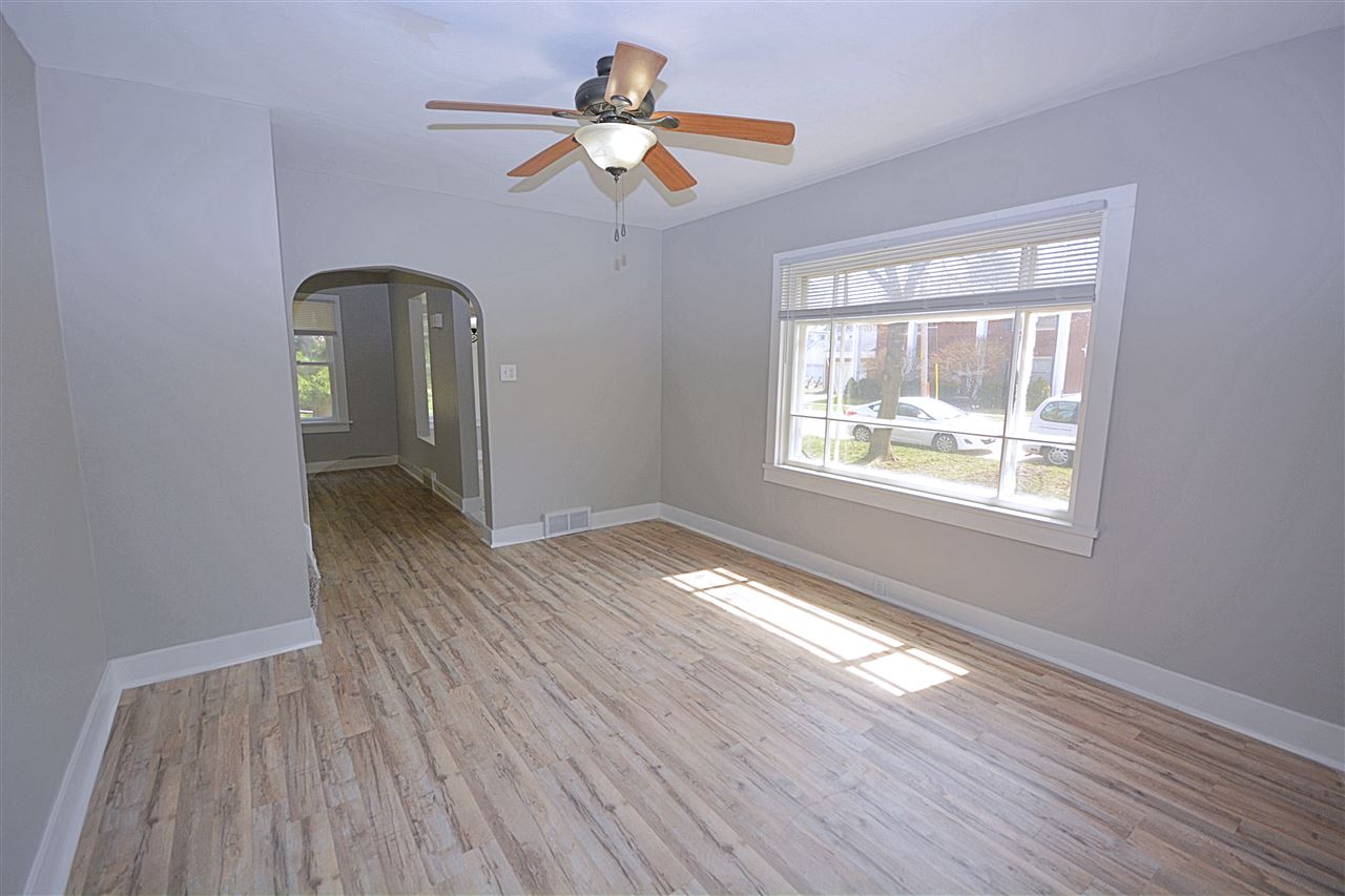 523 10th Avenue Rochelle, IL 61068 - Photo 5 of 22 a view of an empty room with wooden floor and a window