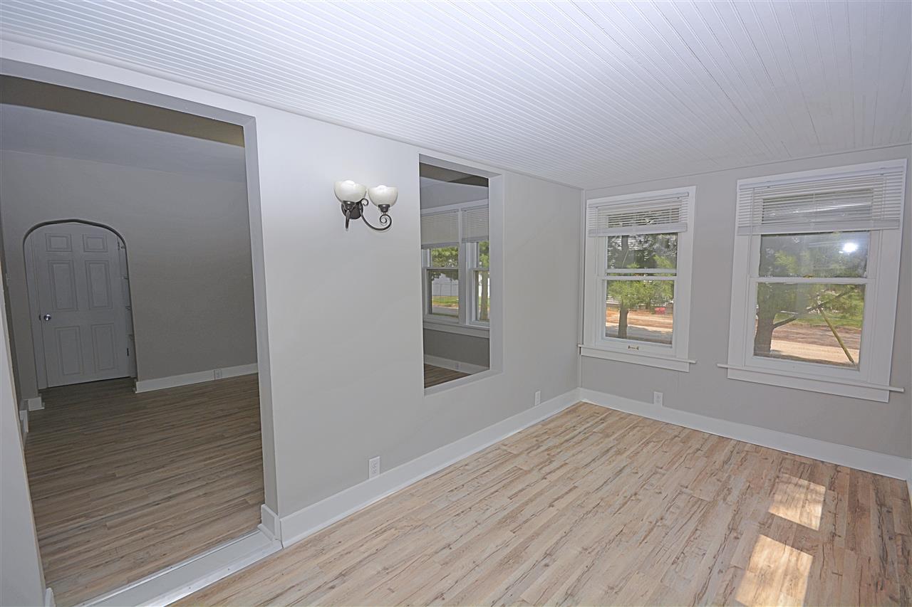 523 10th Avenue Rochelle, IL 61068 - Photo 6 of 22 a view of an empty room with wooden floor and a window