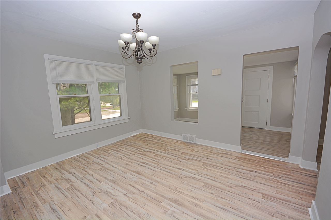 523 10th Avenue Rochelle, IL 61068 - Photo 7 of 22 a view of an empty room with wooden floor and a window