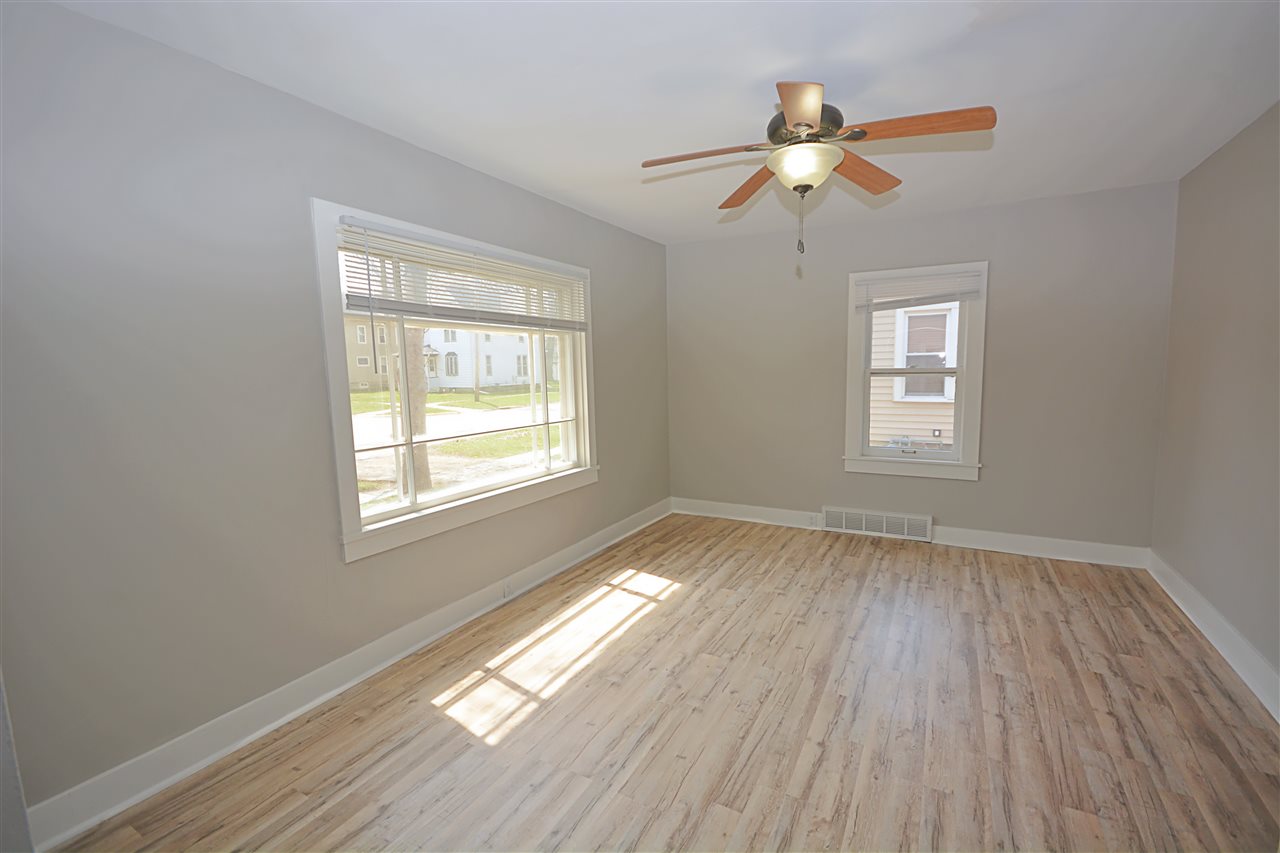 523 10th Avenue Rochelle, IL 61068 - Photo 8 of 22 a view of an empty room with wooden floor and a window