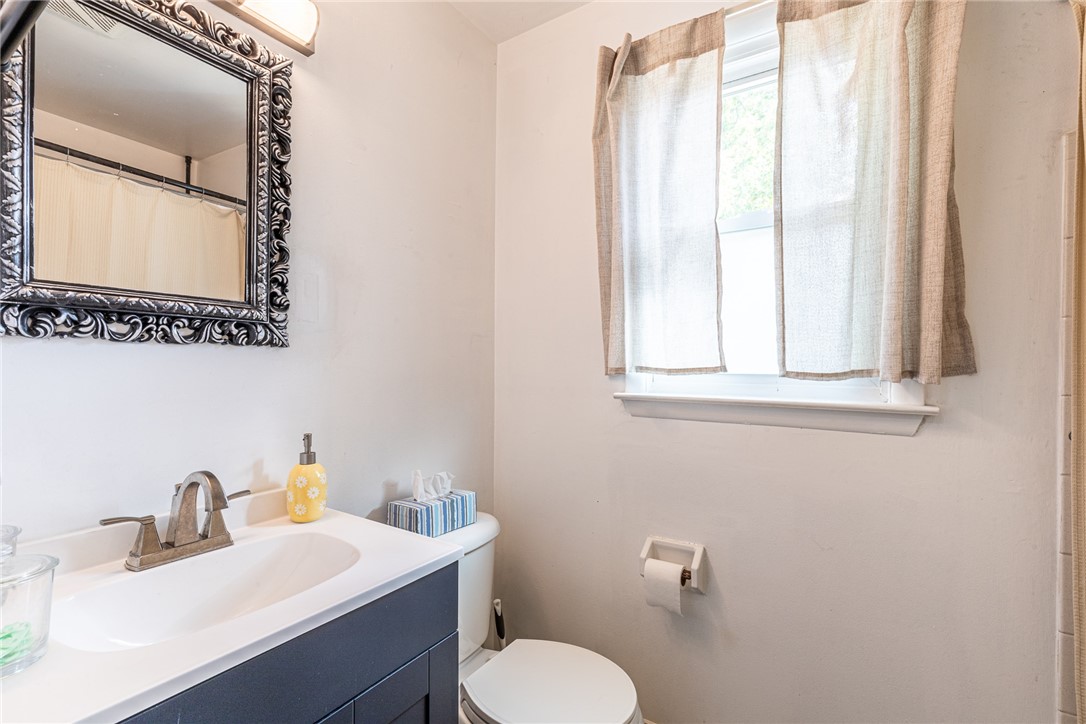 6432 Lakeside Road Ontario, NY 14519 - Photo 21 of 35 A classic mirror accents the functional vanity in this bathroom illuminated by natural window light.