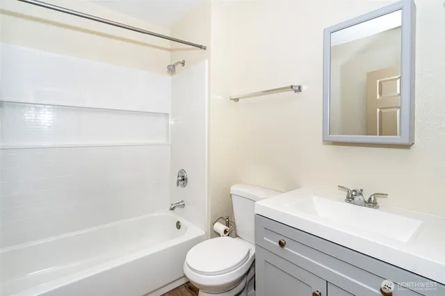 a view of a bedroom with a bed and a window