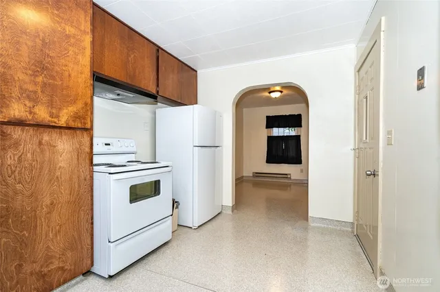 a view of a kitchen with refrigerator and stove