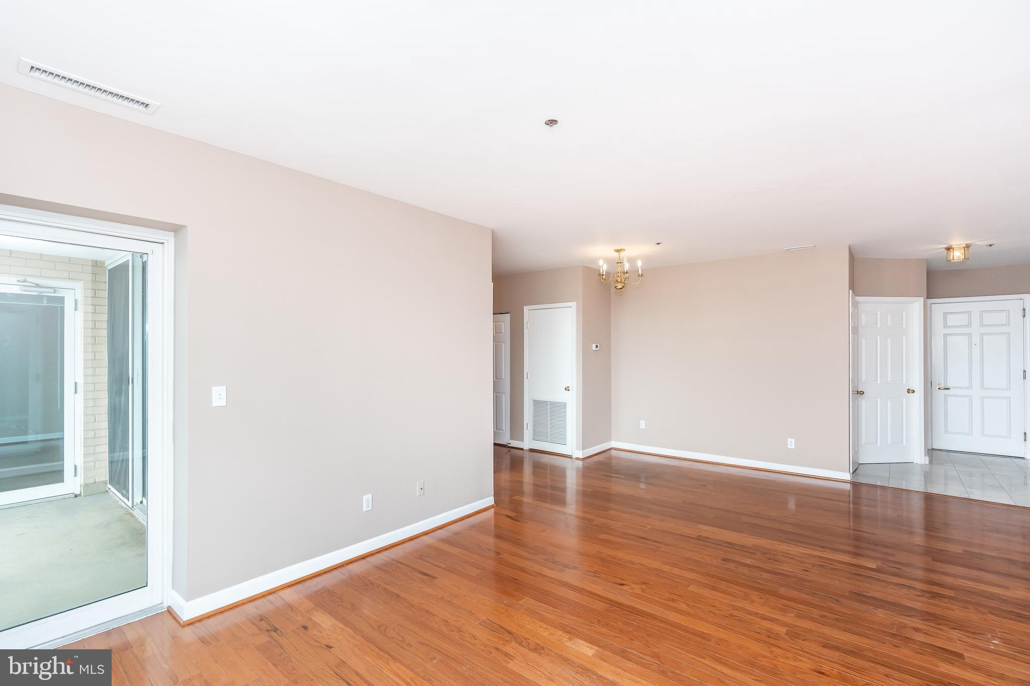 100 Harborview Drive, Unit 1908 Baltimore, MD 21230 - Photo 12 of 60 a view of an empty room with wooden floor