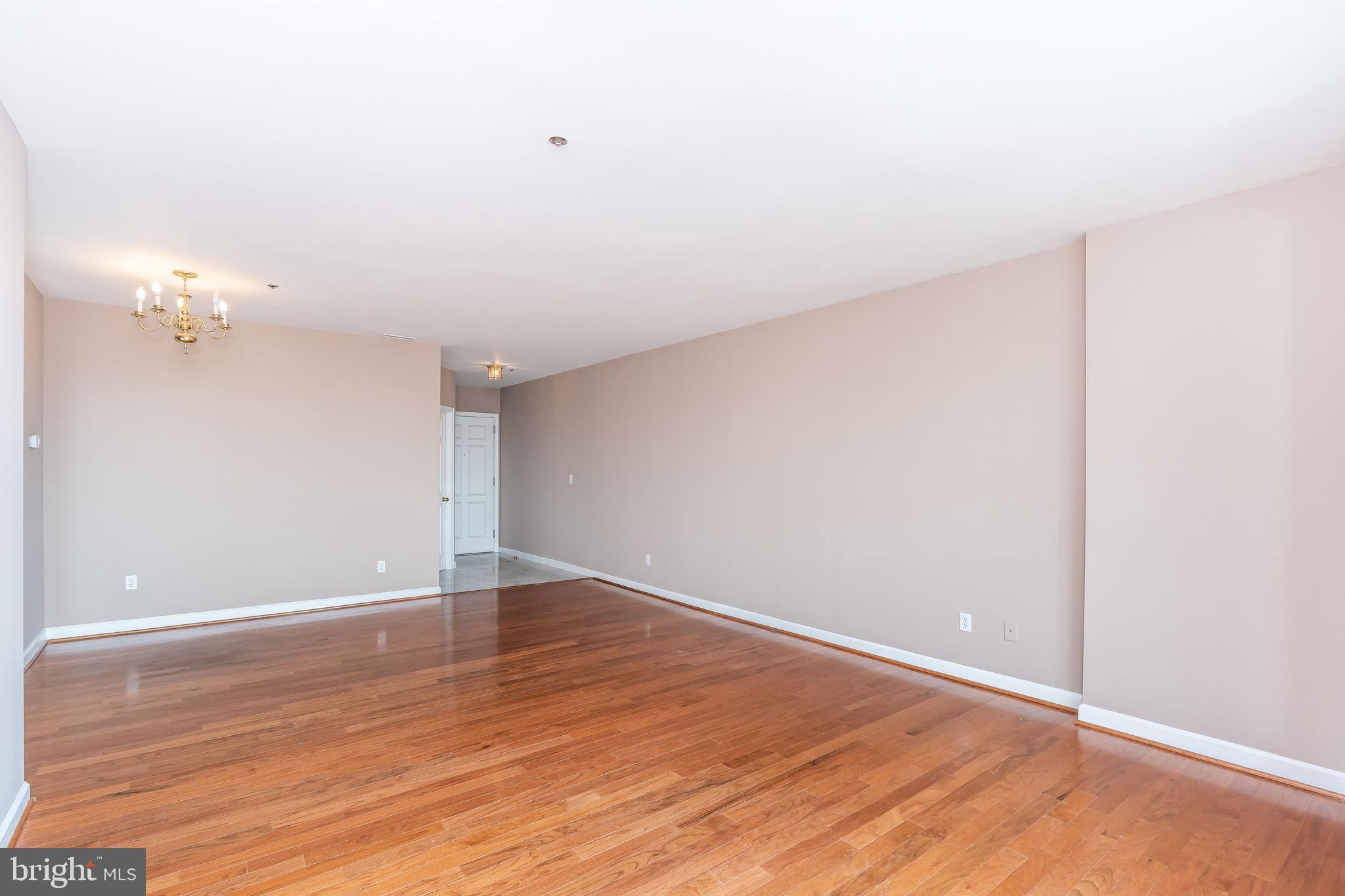 100 Harborview Drive, Unit 1908 Baltimore, MD 21230 - Photo 13 of 60 a view of an empty room with wooden floor