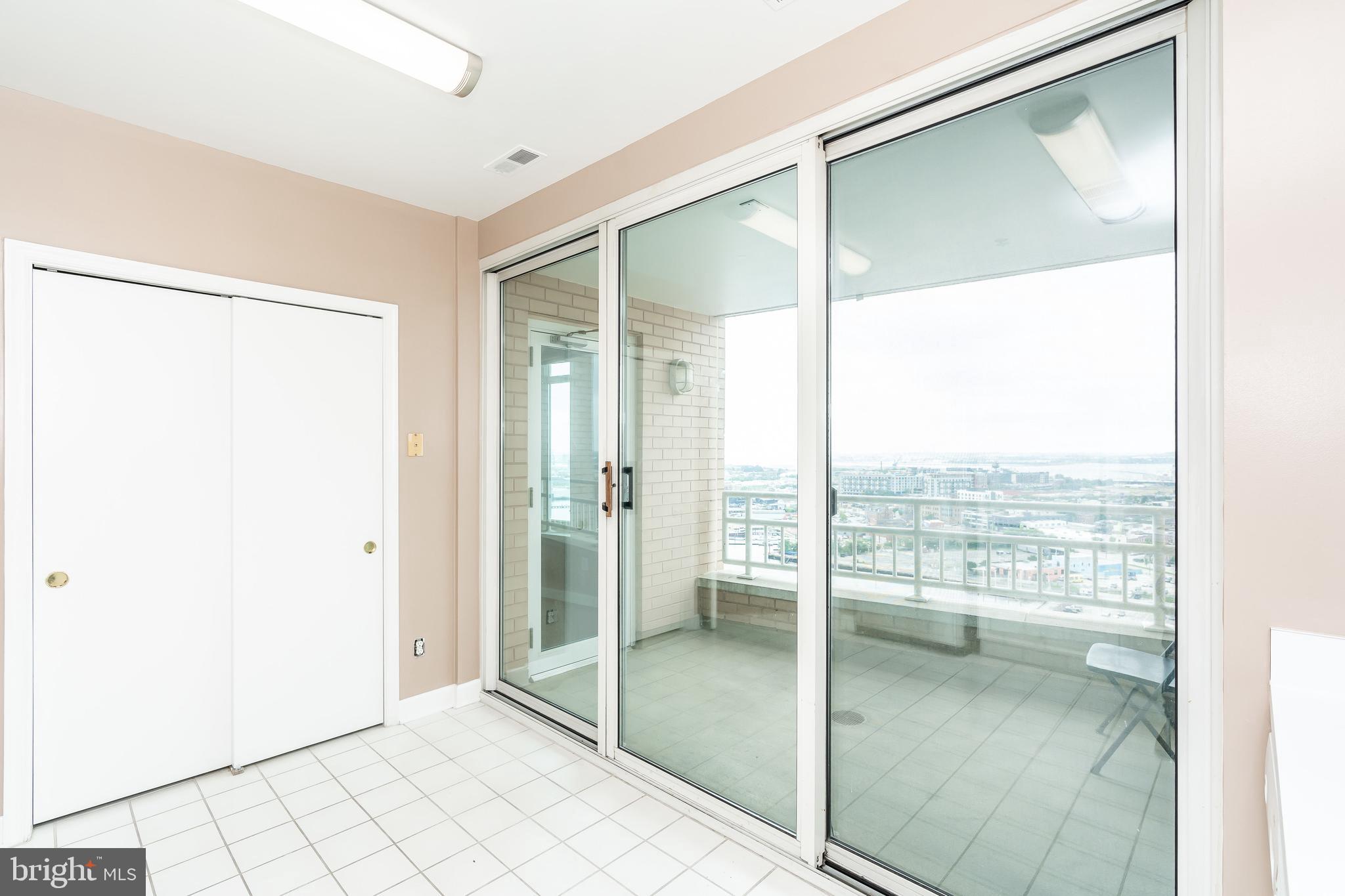 100 Harborview Drive, Unit 1908 Baltimore, MD 21230 - Photo 17 of 60 a bathroom with a glass shower door and a window
