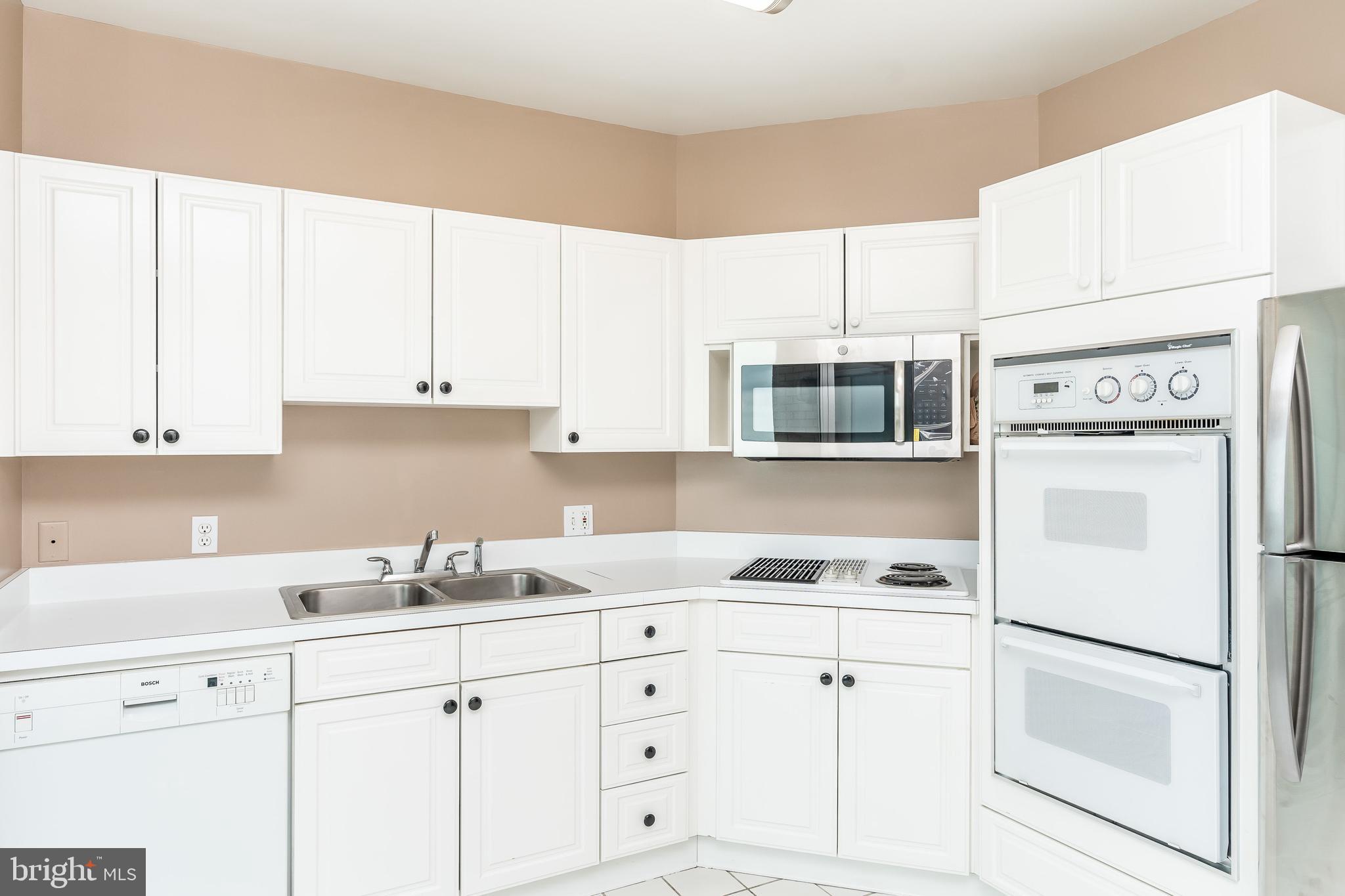 100 Harborview Drive, Unit 1908 Baltimore, MD 21230 - Photo 19 of 60 a kitchen with cabinets and white appliances