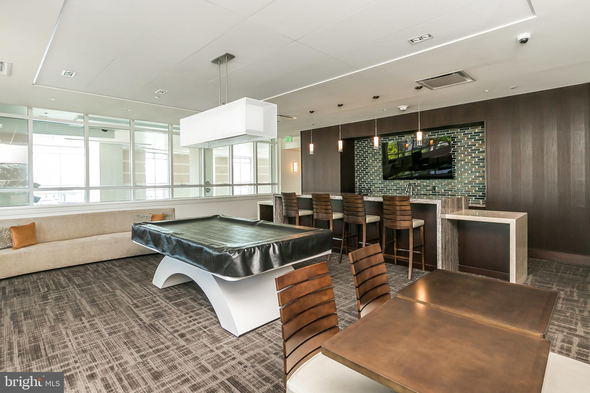 100 Harborview Drive, Unit 1908 Baltimore, MD 21230 - Photo 36 of 60 a living room with furniture a flat screen tv and floor to ceiling window