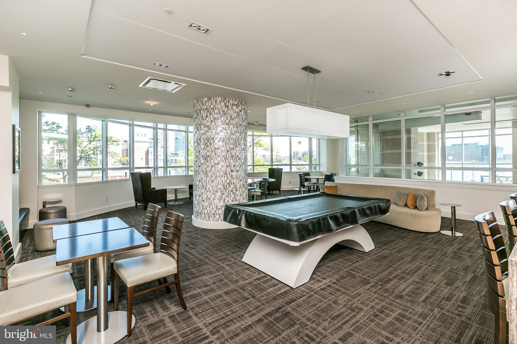 100 Harborview Drive, Unit 1908 Baltimore, MD 21230 - Photo 38 of 60 a living room with furniture a window and a table