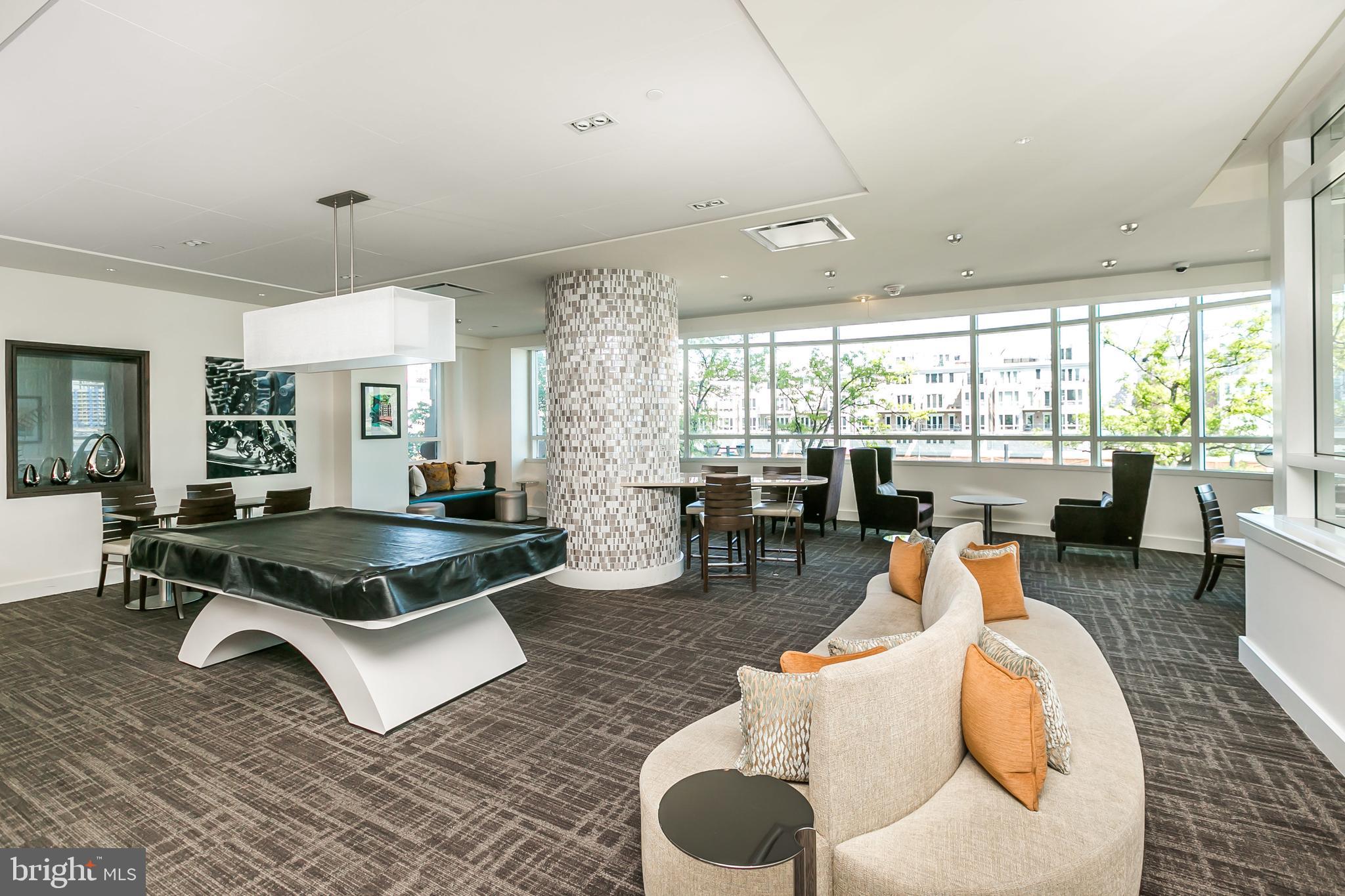 100 Harborview Drive, Unit 1908 Baltimore, MD 21230 - Photo 39 of 60 a living room with furniture a rug and white walls