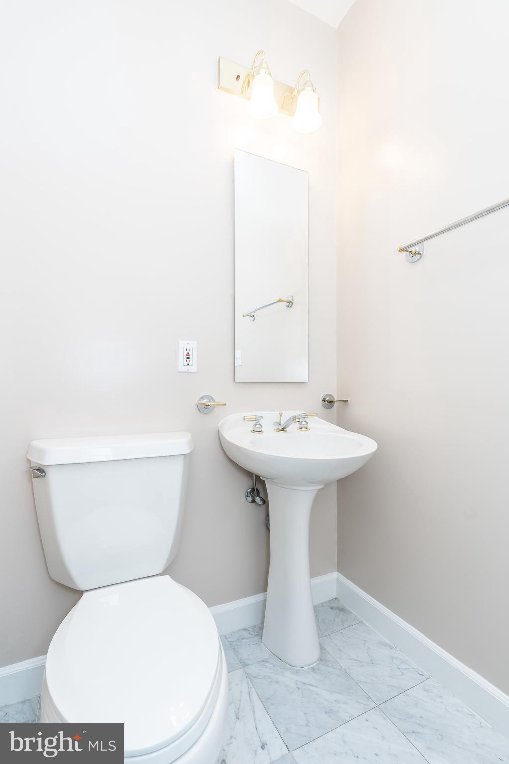 100 Harborview Drive, Unit 1908 Baltimore, MD 21230 - Photo 6 of 60 a white toilet sitting next to a white sink