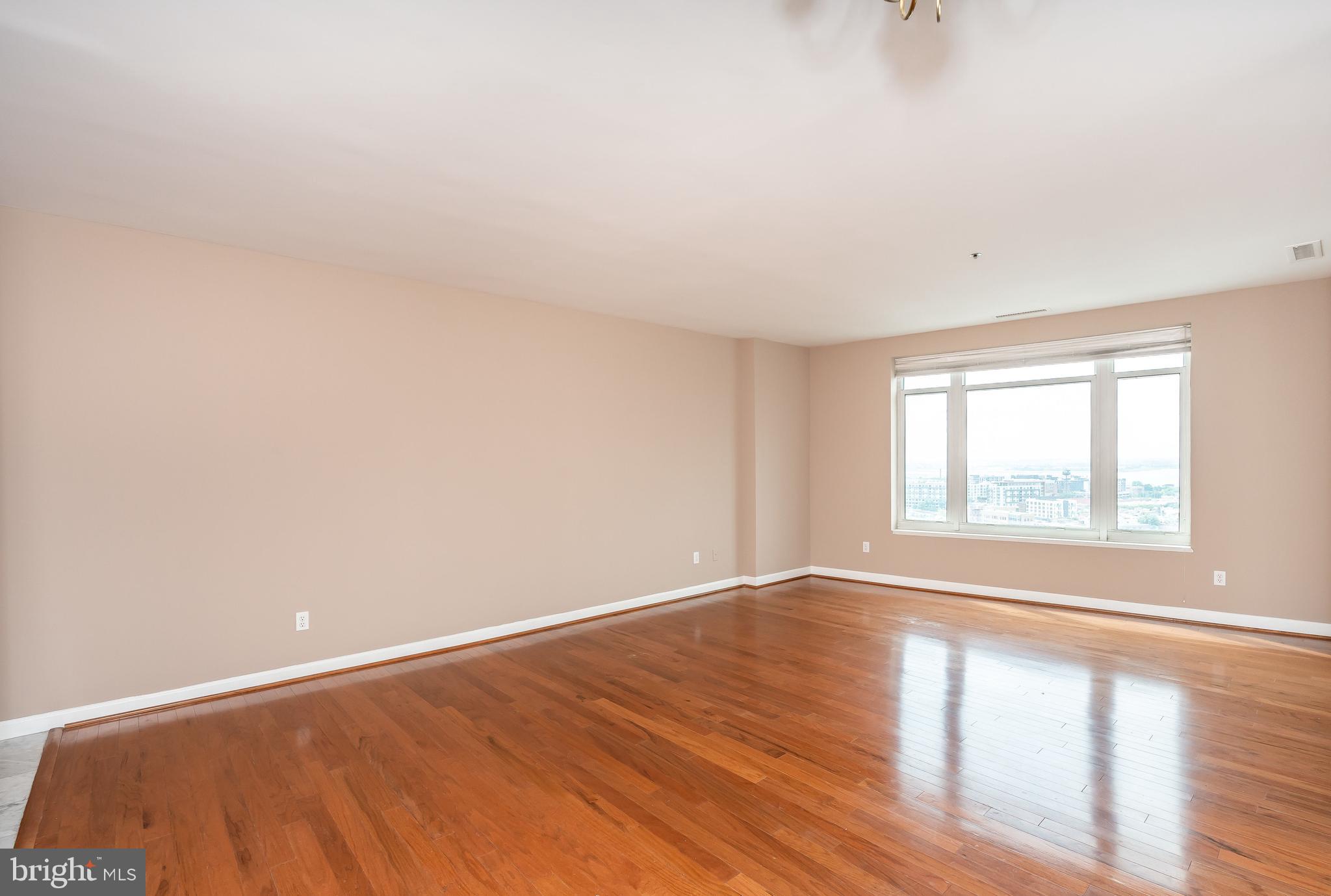 100 Harborview Drive, Unit 1908 Baltimore, MD 21230 - Photo 8 of 60 wooden floor in an empty room with a window