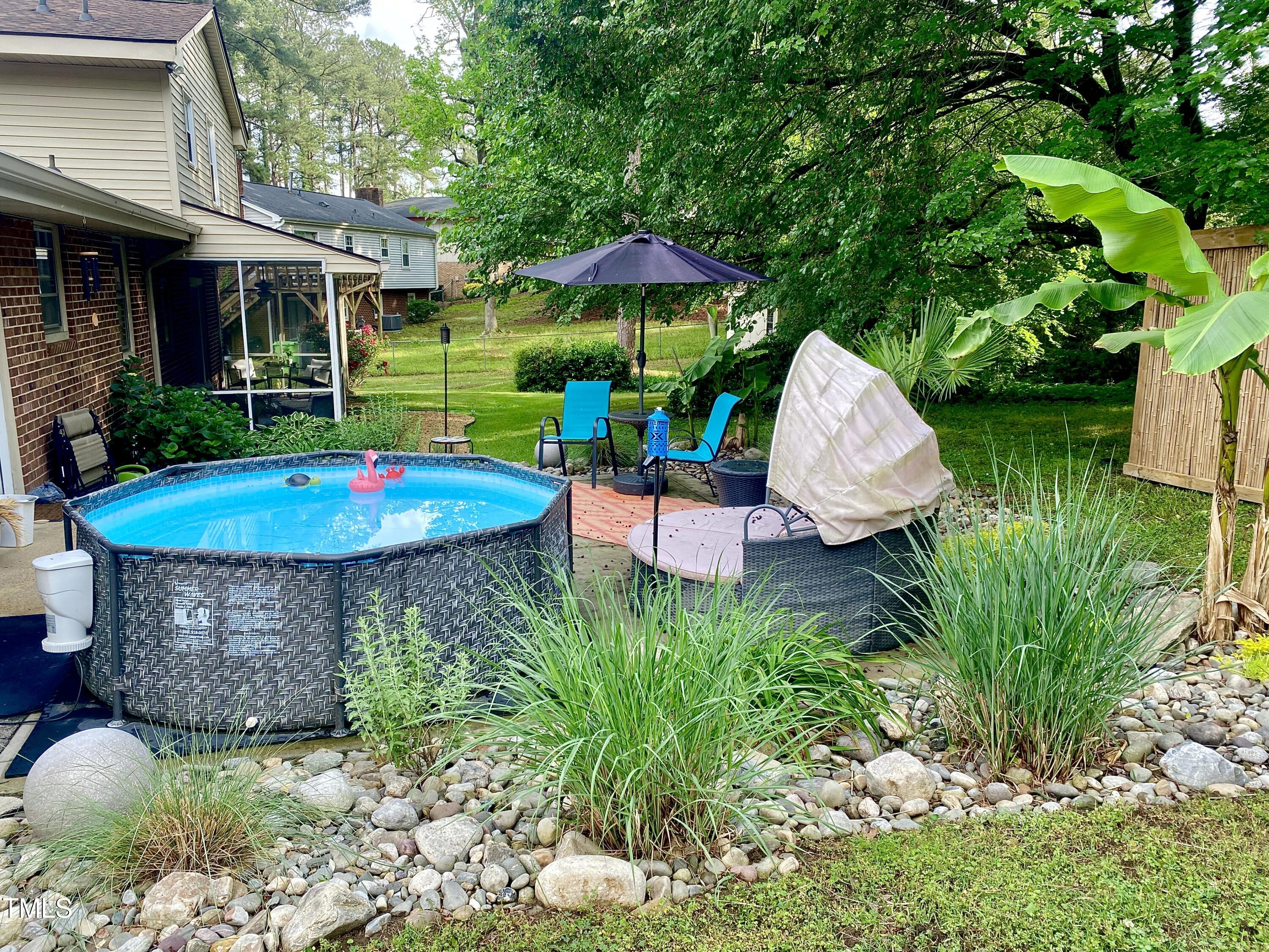 4013 Ingram Drive Raleigh, NC 27604 - Photo 18 of 29 a view of a backyard with plants and a garden