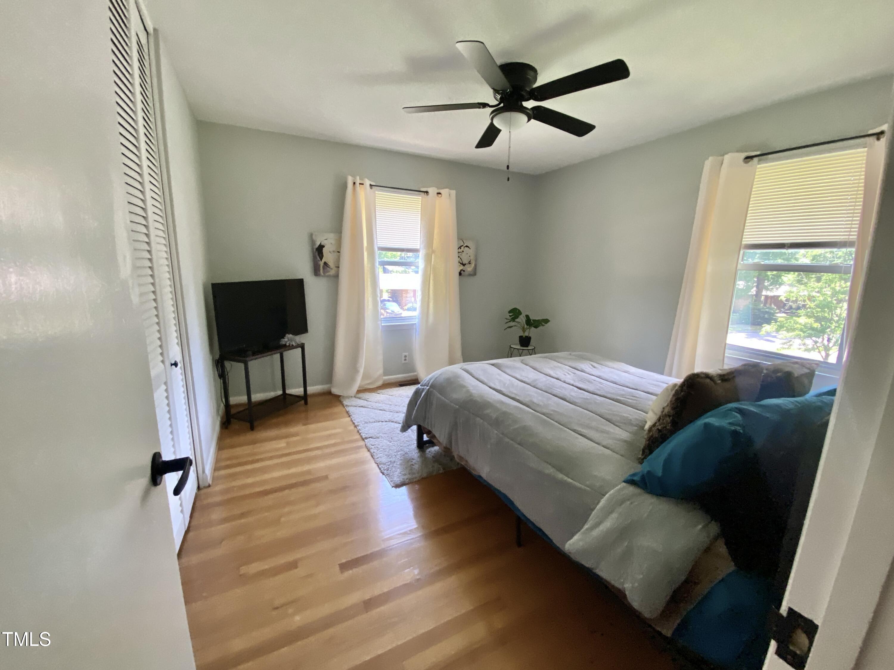4013 Ingram Drive Raleigh, NC 27604 - Photo 23 of 29 a bedroom with a bed and wooden floor