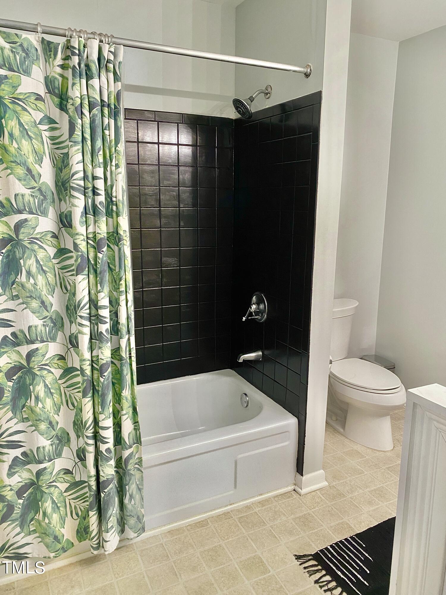 4013 Ingram Drive Raleigh, NC 27604 - Photo 26 of 29 a bathroom with a bathtub and shower