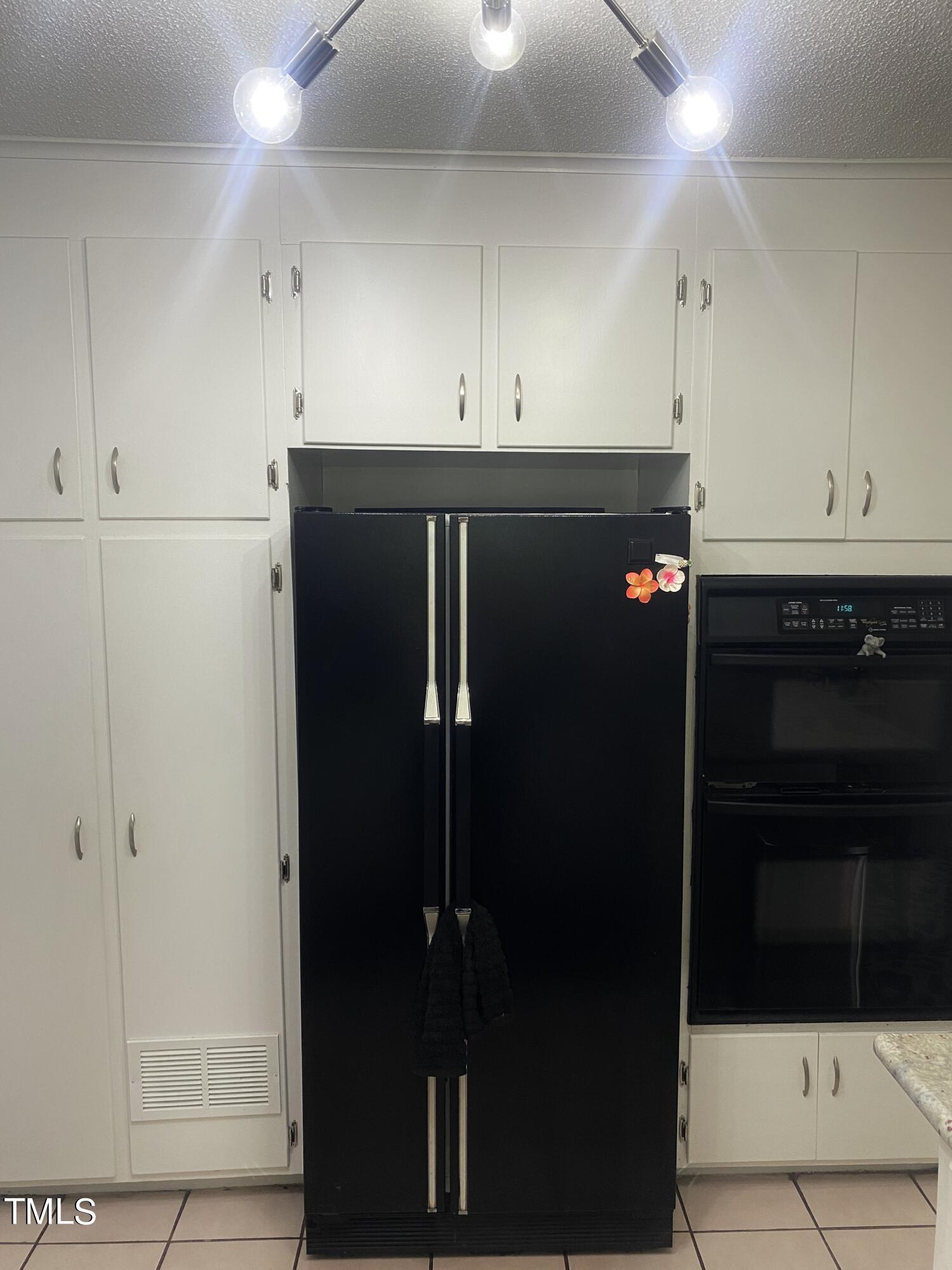 4013 Ingram Drive Raleigh, NC 27604 - Photo 7 of 29 a kitchen with a refrigerator and cabinets