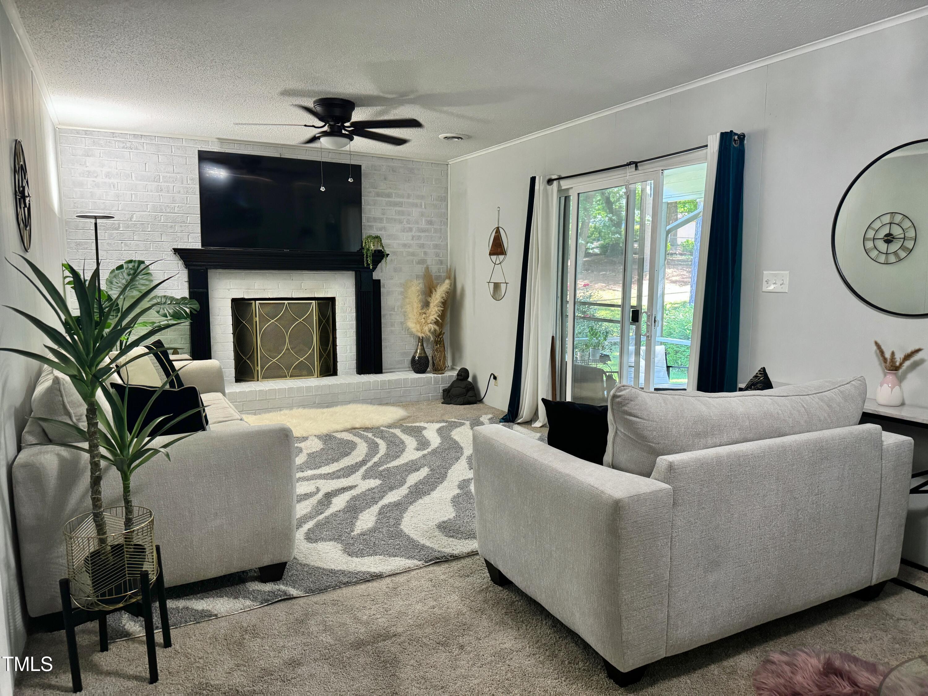 4013 Ingram Drive Raleigh, NC 27604 - Photo 10 of 29 a living room with furniture a large window and a fireplace