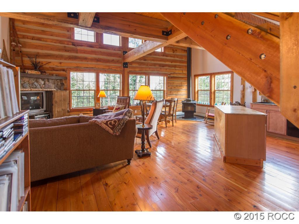 993 Bellows Road Hartsel, CO 80449 - Photo 1 of 24 a living room with furniture a wooden floor and a large window