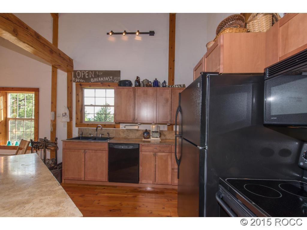 993 Bellows Road Hartsel, CO 80449 - Photo 11 of 24 a kitchen with refrigerator and cabinets