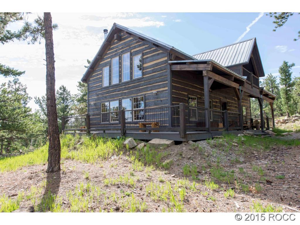 993 Bellows Road Hartsel, CO 80449 - Photo 14 of 24 a backyard of a house with a garden and barbeque oven