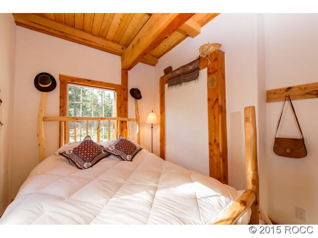 993 Bellows Road Hartsel, CO 80449 - Photo 16 of 24 a bedroom with a bed and a window