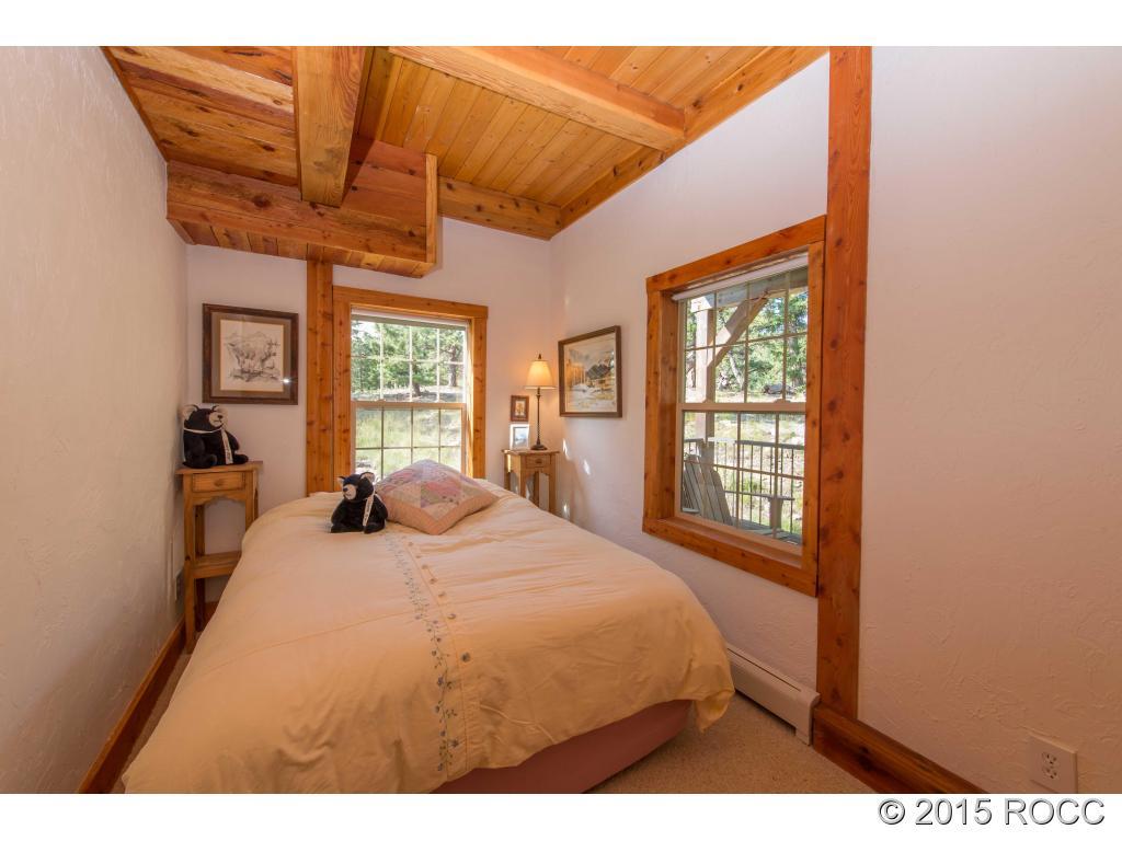 993 Bellows Road Hartsel, CO 80449 - Photo 20 of 24 a bedroom with a bed dresser and a window