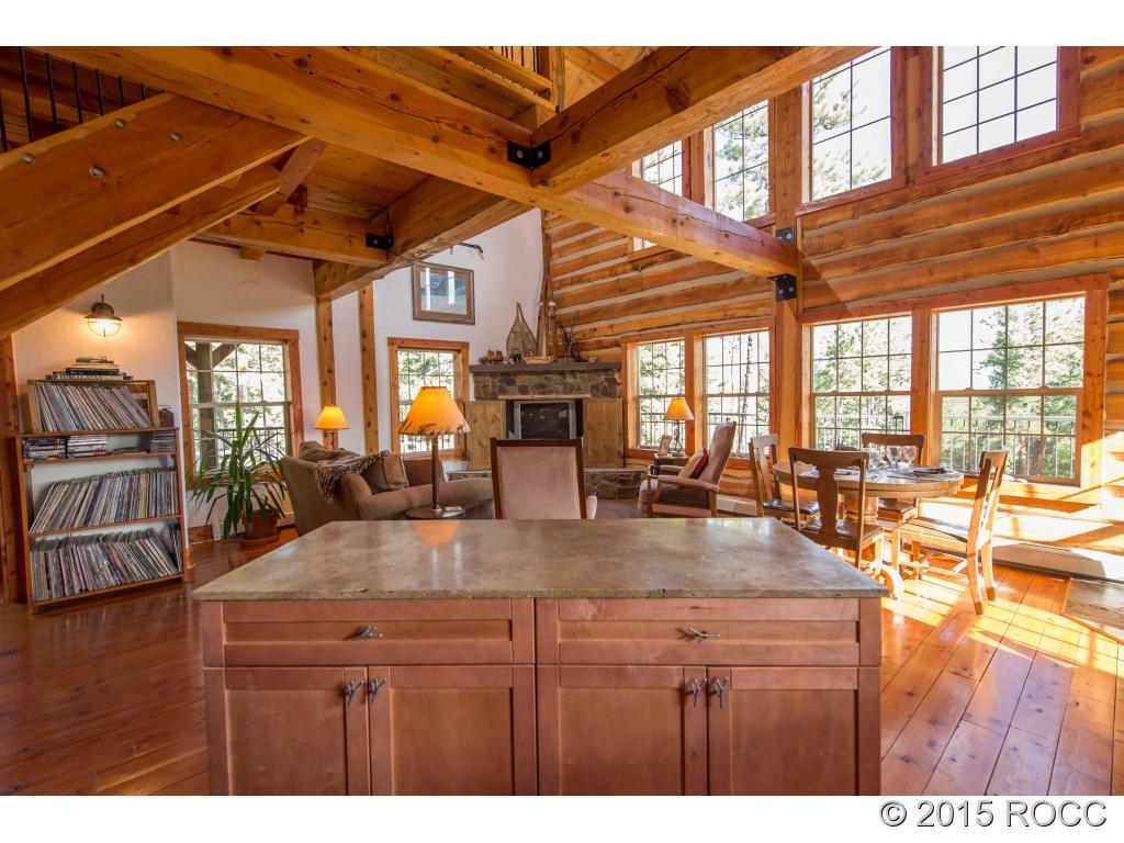 993 Bellows Road Hartsel, CO 80449 - Photo 5 of 24 a kitchen with a refrigerator a stove and a wooden cabinets