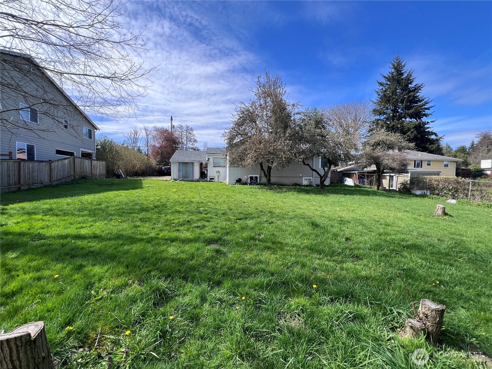 13404 Military Road South Tukwila, WA 98168 - Photo 8 of 10 a view of a yard with a house in the background