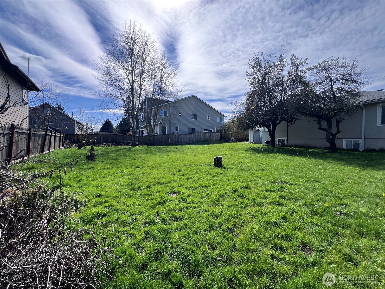13404 Military Road South Tukwila, WA 98168 - Photo 9 of 10 a white house with a big yard and large trees