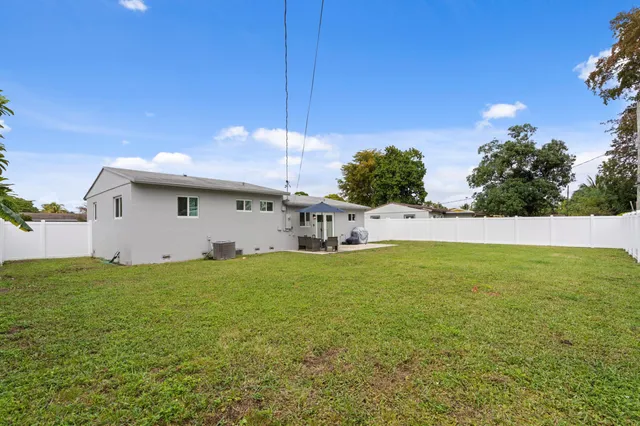 a view of a swimming pool and a yard