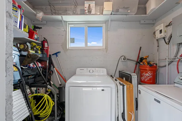 a view of a house with a yard and potted plants