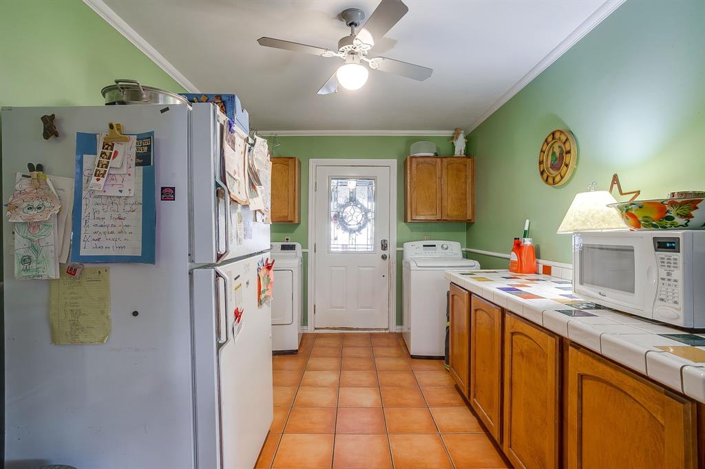 205 West Ridge Street Weatherford, TX 76086 - Photo 15 of 34 a kitchen with a refrigerator and countertop