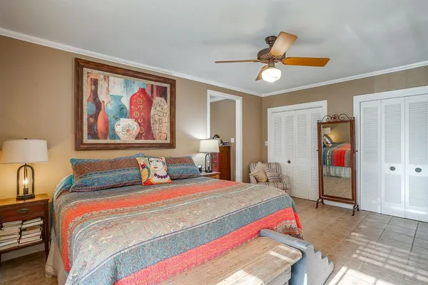 a bedroom with bed and a chandelier