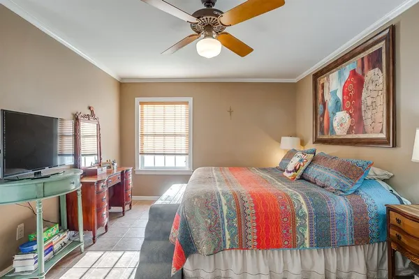 a bedroom with bed tv and window