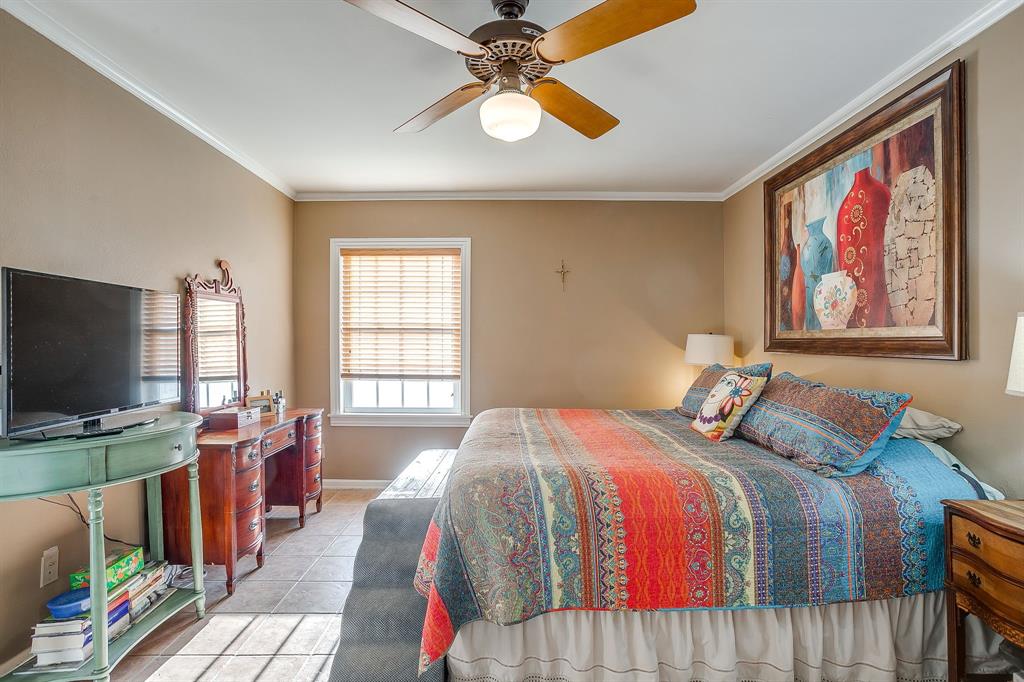 205 West Ridge Street Weatherford, TX 76086 - Photo 18 of 34 a bedroom with bed tv and window