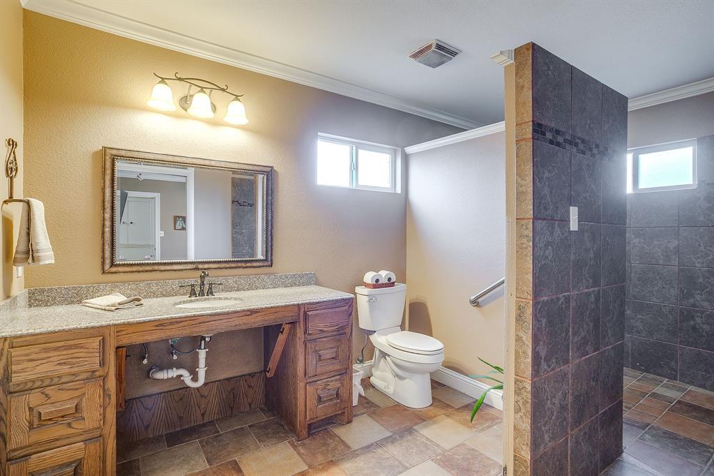 205 West Ridge Street Weatherford, TX 76086 - Photo 24 of 34 a bathroom with a sink a toilet and shower