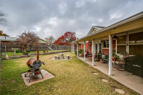 a swimming pool with outdoor seating yard and barbeque oven