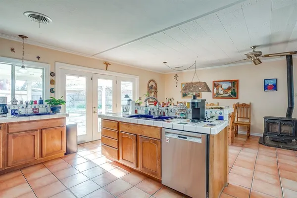 a kitchen with stainless steel appliances granite countertop a sink and cabinets