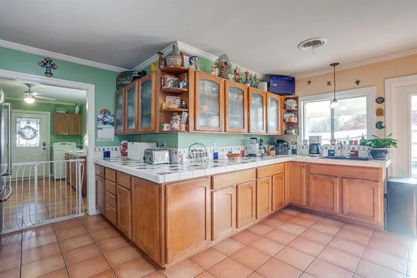 a kitchen with stainless steel appliances granite countertop a sink and cabinets