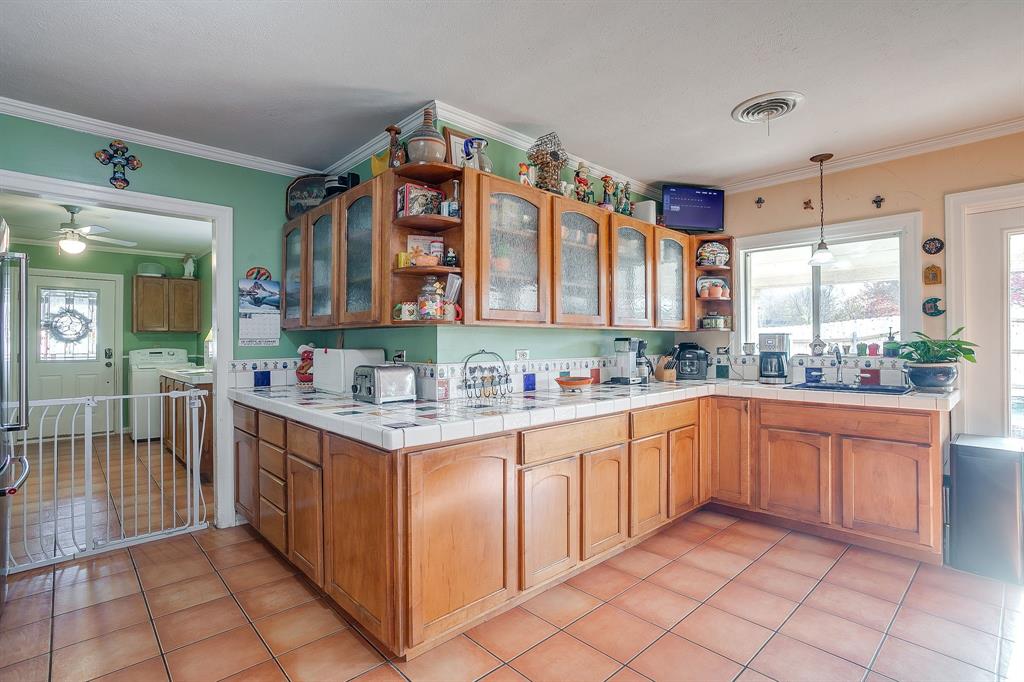 205 West Ridge Street Weatherford, TX 76086 - Photo 10 of 34 a kitchen with stainless steel appliances granite countertop a sink and cabinets