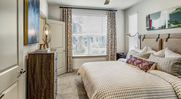 a bedroom with a bed and a mirror