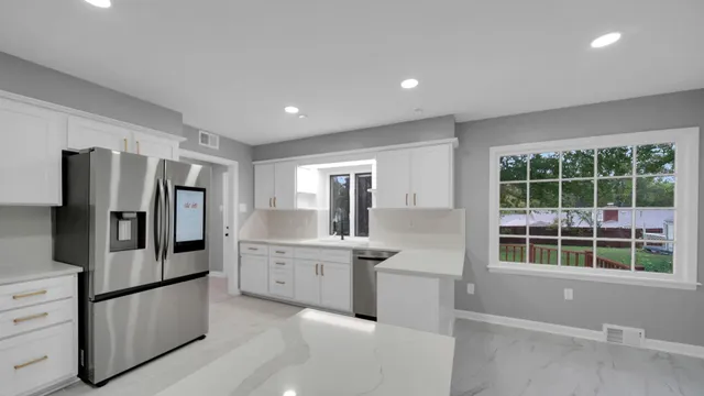 a kitchen with stainless steel appliances granite countertop a refrigerator and a sink