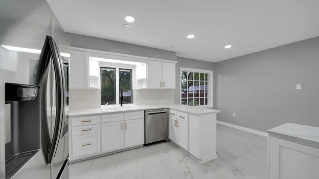 a view of a kitchen with a sink dishwasher and a refrigerator